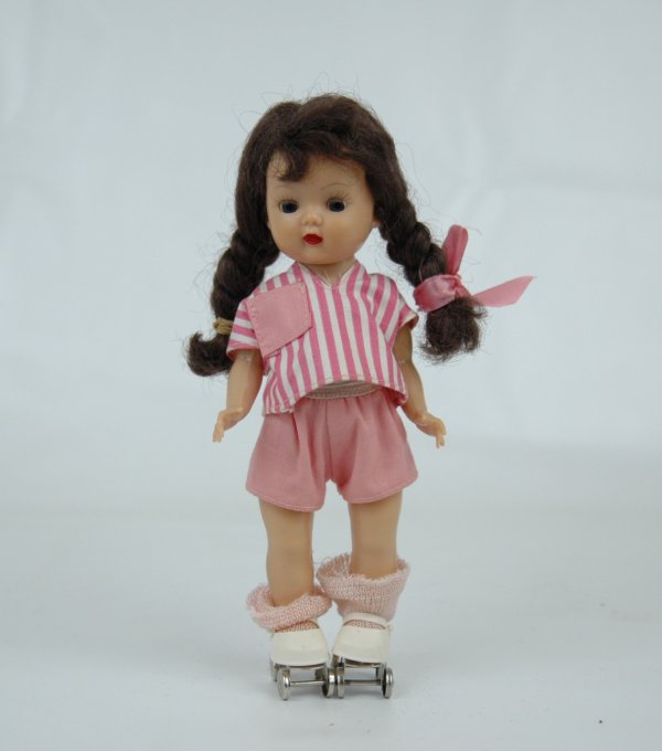 Muffie doll by Nancy Ann, 7 1/4", hard plastic walke: Muffie doll by Nancy Ann, 7 1/4", hard plastic walker, marked on back "STORY BOOK DOLLS, CALIFORNIA, MUFFIE", brown hair, blue eyes, untagged pink striped shirt, pink shorts, pink socks and roller ska