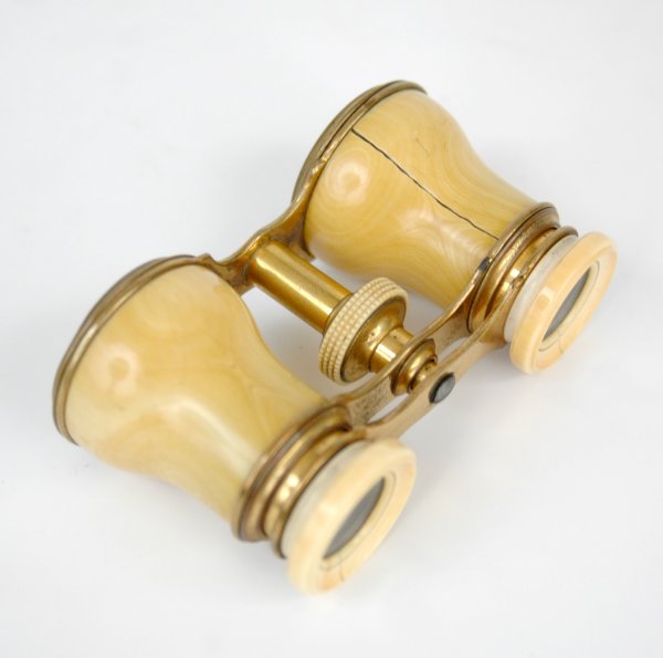 Ivory cased opera glasses, 4 1/2" x 2 1/4" x 1 1/2: Ivory cased opera glasses, 4 1/2" x 2 1/4" x 1 1/2". Late 19th to early 20th C. Cracks in ivory on each ring around lens and down body of one side, possibly replaced screw.