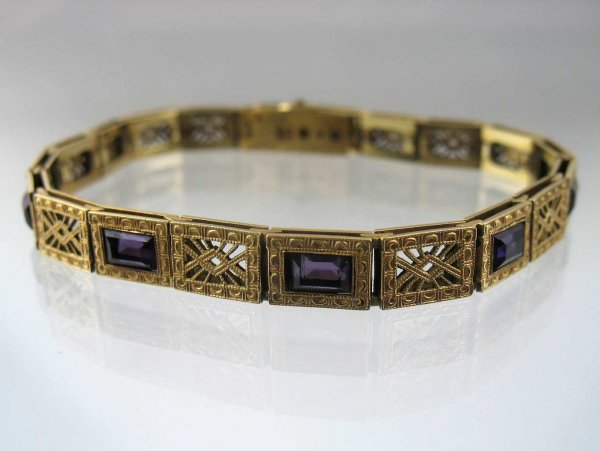 Simmons gold filled filigree bracelet with purple : Simmons gold filled filigree bracelet with purple stones, 1/4" wide, 7 1/4" long, set with five emerald cut purple glass stones, marked Simmons, C. 1920, no visible defects