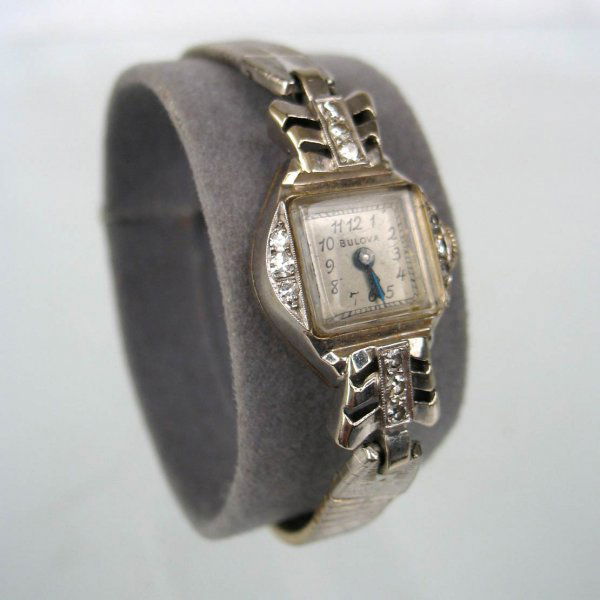 Lady's Bulova 14k white gold and diamond wristwatc: Lady's Bulova 14k white gold and diamond wristwatch, case measures 1 1/2" long x 3/4" wide, face is 1/2" x 1/2", set with twelve round diamonds measuring approximately 3 points each, 21 jewel movement