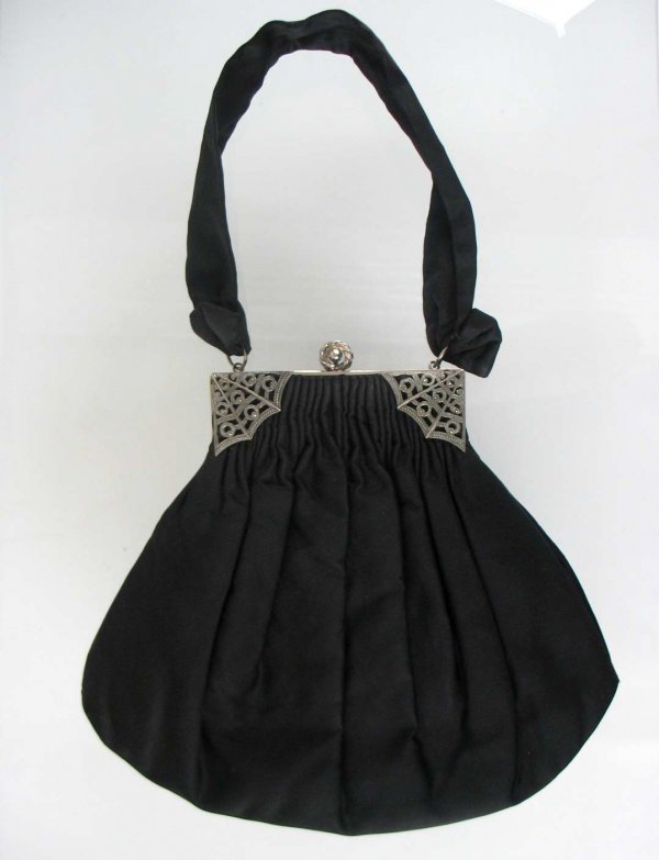 Black fabric purse with marcasite frame, 8 1/2" lo: Black fabric purse with marcasite frame, 8 1/2" long x 9" wide at widest part, silver tone frame measures 4 3/4" across and is set with marcasites in a spider web motif, 14" fabric handle, marked Guil