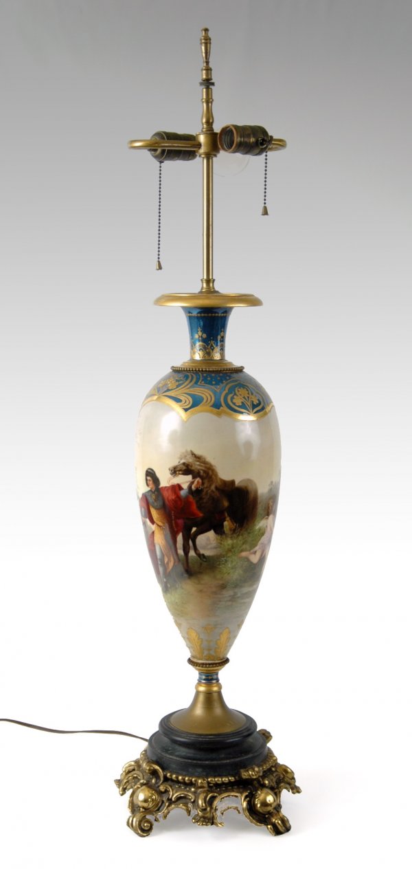 Hand painted porcelain table lamp, signed E. Volk,: Hand painted porcelain table lamp, signed E. Volk, landscape with figures and cherubs, gold enameling on blue ground at top and bottom, mounted on wood and metal bases, two light, 36" high x 11" acros