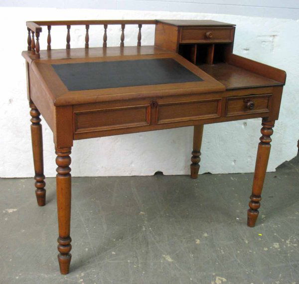 Postmaster's desk, rectangular top with gallery on: Postmaster's desk, rectangular top with gallery on left, short drawer over three pigeonholes on right, slant front with leather writing surface lifts to reveal interior pigeonholes and storage, one sh