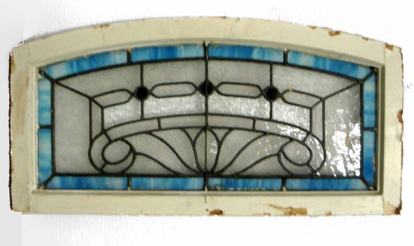 Stained and slag glass arched transom window, thre: Stained and slag glass arched transom window, three jewels, early 20th C. 16" x 32".