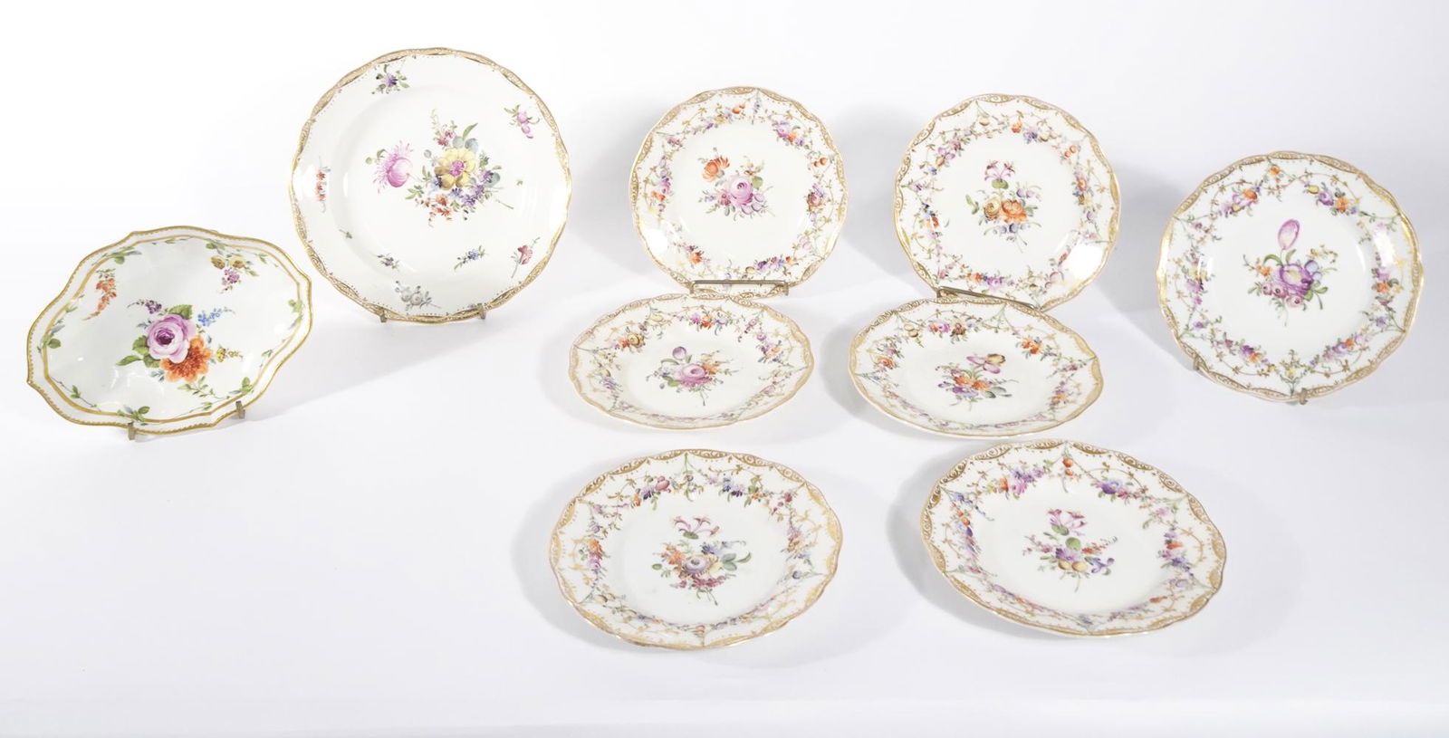 Meissen dish and plate grouping: Meissen dish and plate grouping with hand painted floral designs, nine pieces, early 20th C., 1 3/4" x 7" dish, 7 3/4" shallow plate and (7) 6 1/4" plates