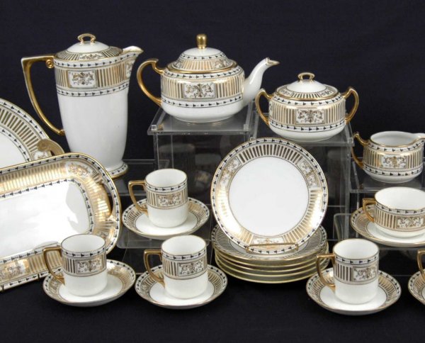 Nippon dessert set, thirty-five pieces, enameled gi: Nippon dessert set, thirty-five pieces, enameled gilt and black bellflower decoration on white porcelain ground, set includes coffee pot 8 3/4", teapot, creamer, sugar, handled cake plate, oval tray, 