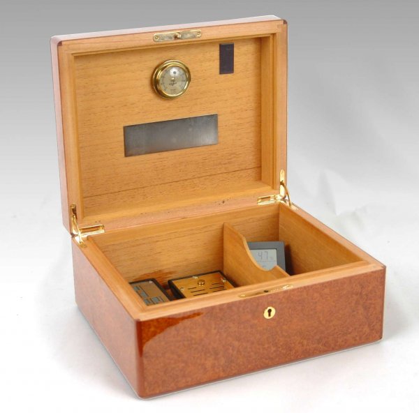 Elie Bleu Paris humidor, lacquered bird's eye mapl: Elie Bleu Paris humidor, lacquered bird's eye maple case, mahogany interior with attached Hygro moisture dial, measures, impressed name on brass lock and key, 5 1/4" high x 11 3/4" x 9 3/4", late 20th