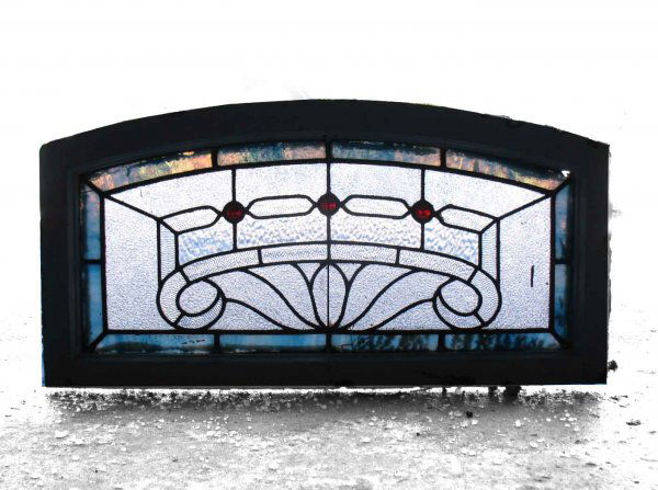 Stained and slag glass arched transom window, thre: Stained and slag glass arched transom window, three jewels, 16" x 32", early 20th C.