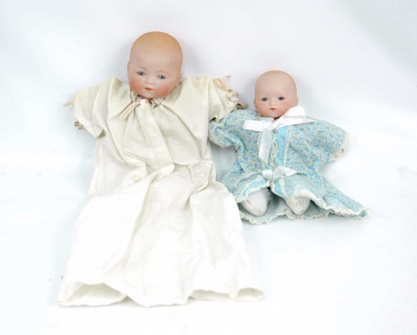 Two bisque head babies with cloth bodies and compo: Two bisque head babies with cloth bodies and compo hands, including 12" A. M. with blue stationary eyes, closed mouth, crier in body does not work; and 10" marked Germany on back of head, blue sleep e
