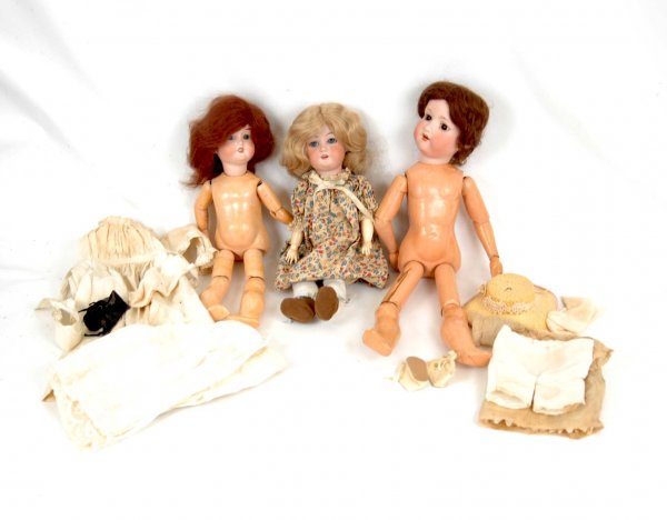 Three bisque head dolls, including bisque head dol: Three bisque head dolls, including bisque head doll, 19", compo over papier mache body, wood jointed arms and upper legs, compo lower legs and hands, brown open eyes, open mouth with teeth, brown wig,