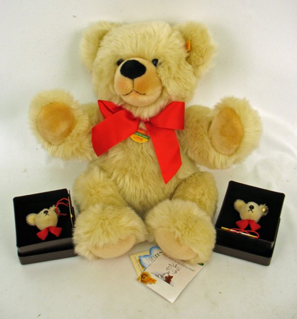 Steiff bear, 16", with gold ear button and cloth t: Steiff bear, 16", with gold ear button and cloth tag, paper neck tag "Bobby, Cosy Friends", additional tags on left foot, cream colored fur, red bow around neck, two Steiff pins in original boxes (one
