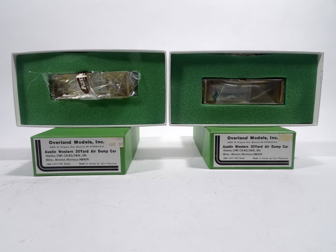 Two brass HO gauge Austin Western 30 yard air side dump: Two 1980's brass HO gauge Austin Western 30 yard air side dump cars in original boxes, Overland Models by AJIN (Korea) unpainted. Both cars are still wrapped in factory plastic. Boxes each measures ab