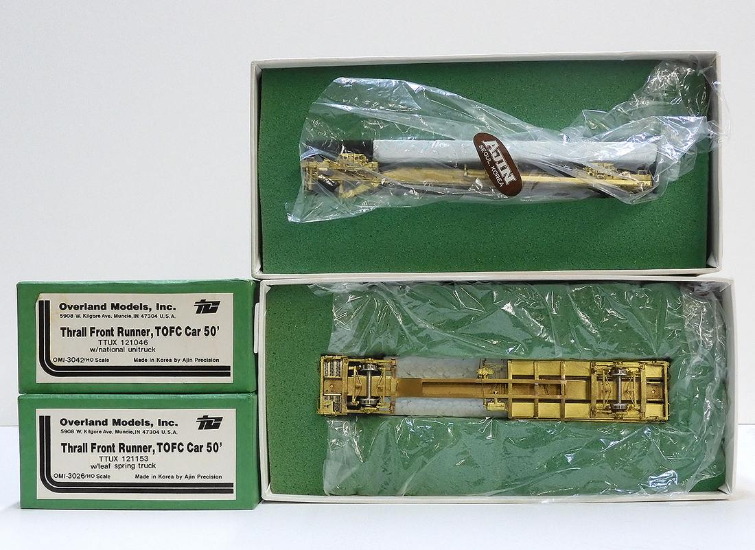 Two brass HO gauge Thrall Frontrunner 50' TOFC cars in: Two 1980's Overland Models by AJIN (Korea) unpainted brass HO gauge Thrall Frontrunner 50' TOFC cars in original boxes. Both still wrapped in factory plastic. Boxes each measure approx. 10" X 5" X 3".