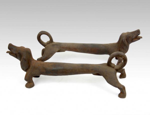 Pair of cast iron Dachshund andirons, open mouths: Pair of cast iron Dachshund andirons, open mouths and curled tails, 8" high x 21" across x 4" deep, early 20th C.
