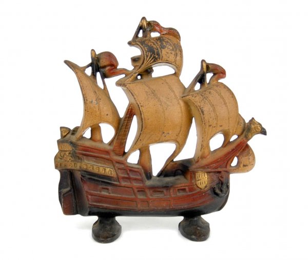 Cast iron sailing ship doorstop with eagle figureh: Cast iron sailing ship doorstop with eagle figurehead, marked on back 403, COPY R 1930, Cutright Creations Co., 11 3/4" high x 11 1/2" across x 3 1/2" deep.