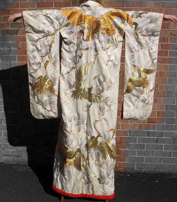Japanese silk kimono, silver, gold and red embroid: Japanese silk kimono, silver, gold and red embroidery on cream colored background, red lining, padded hem, 72" long from neck to hem, early 20th C.