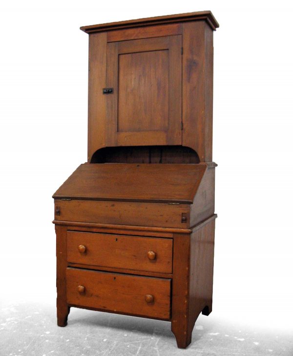 Soft wood slant front desk, three piece, the top s: Soft wood slant front desk, three piece, the top section with overhanging cornice over single recessed paneled door, sits on slant front desk which opens to expose interior pigeonholes and short drawe