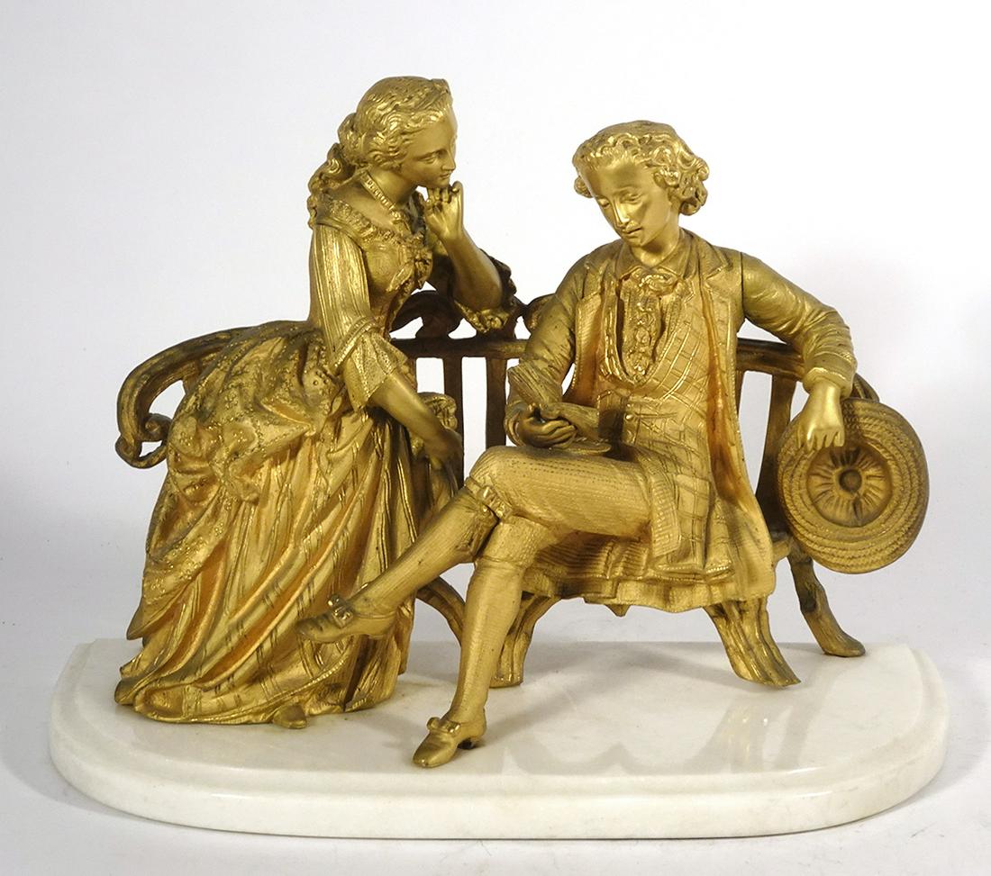 Continental Gilt Metal Figure Group: Continental gilt metal figure group, depicts an elegantly dressed gentleman on a settee reading a book with an elegantly dressed female seated to his right and staring at him, late 19th c., unsigned, 