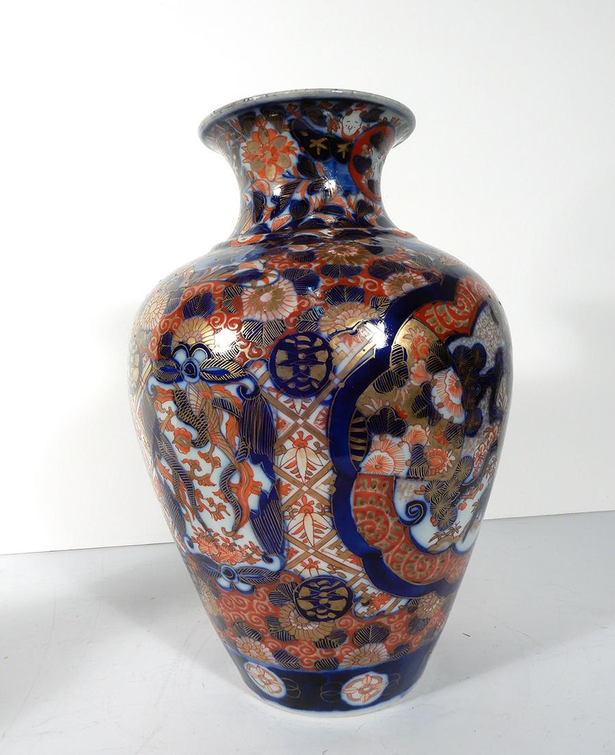Antique Japanese Imari Porcelain Vase: Antique Japanese Imari porcelain vase, overall floral design with children's heads beneath the top rim, unsigned, circa 1868-1912 Meiji period, 10 1/4"