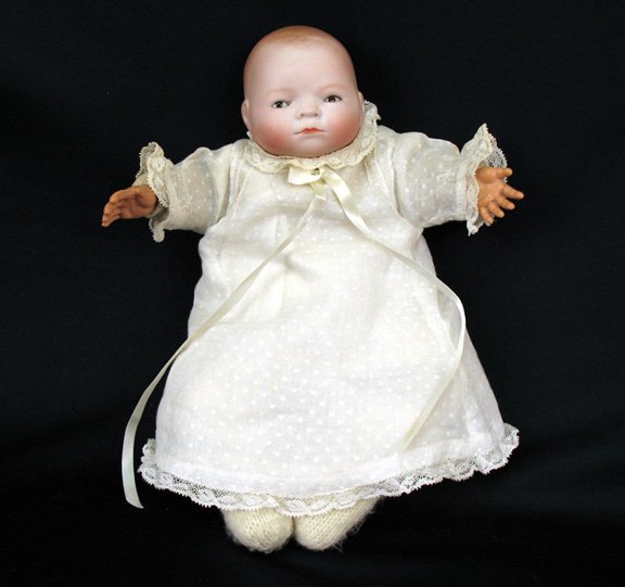 Byelo bisque head baby, Grace Putnam, Germany: Byelo bisque head baby, marked Grace Putnam, Made in Germany on back of head, 9", cloth body, celluloid hands, sleep eyes, early clothing