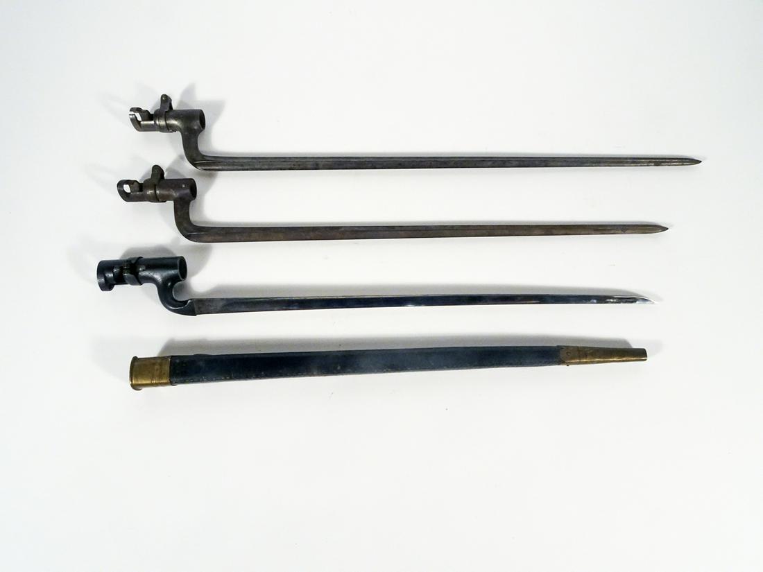 Three British Spike Socket Bayonets: Three British Spike Socket bayonets, 17 1/2" 18 1/2" and 20" length with triangular edge blades, 17 1 2" ricasso is marked "E above a crown and the number 25", 18 1/2" ricasso is marked "D with a crow