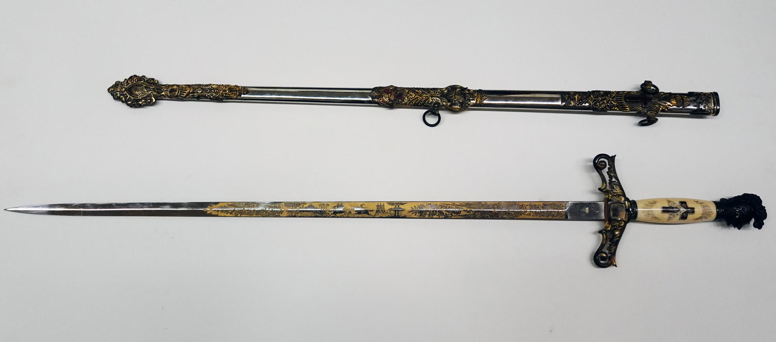 Knights of Columbus Organizational Sword: Antique Knights of Columbus organizational dress sword, 28" straight blade with slight fuller groove, engraving on the blade is a geometrical floral scroll design with a Knight in armor and the name "