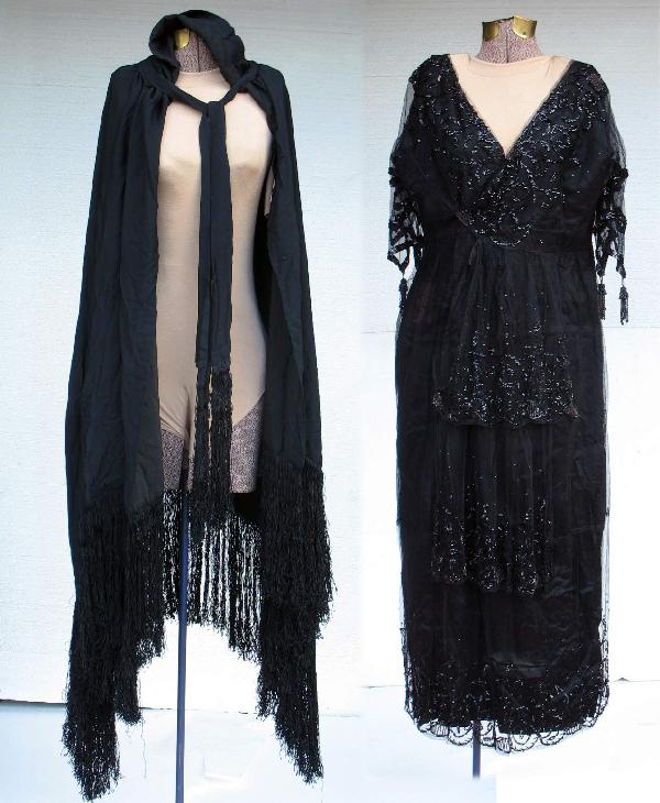 Black fringed cloak and beaded dress, hooded cloak: Black fringed cloak and beaded dress, hooded cloak is made from synthetic silk, 31" long in front plus 10" fringe, handkerchief hem; dress is beaded on mesh and measures 50" long from top of shoulder,