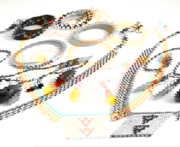 Grouping of South American and African jewelry, fo: Grouping of South American and African jewelry, four bracelets, including bangle with carved dog design, woven bracelet with zig-zag design, a beaded bracelet, carved shell bracelet, and two necklaces