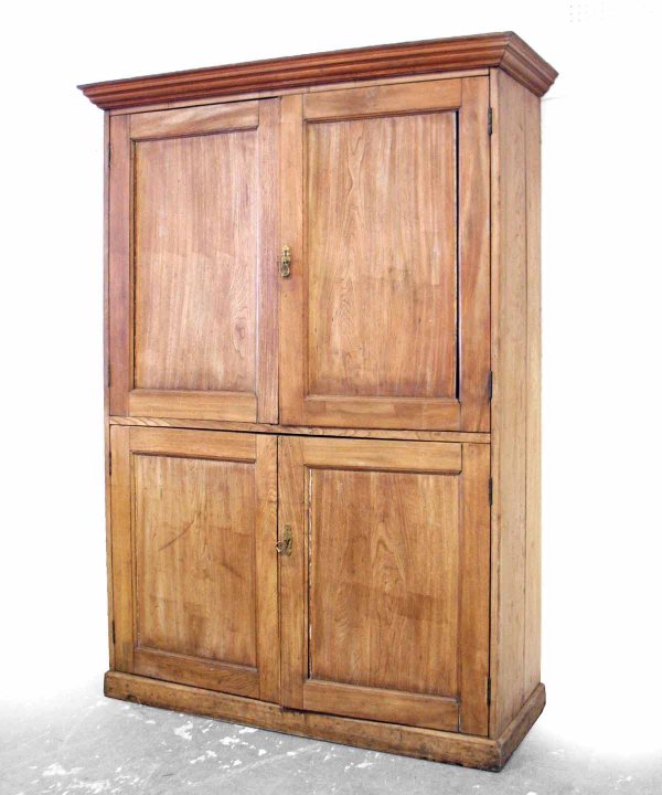 English linen press, overhanging molding over two : English linen press, overhanging molding over two recessed paneled doors, above two recessed paneled lower doors, molded base, interior shelves, 85" high x 53 1/2" across x 19 1/2" deep, late 19th to 
