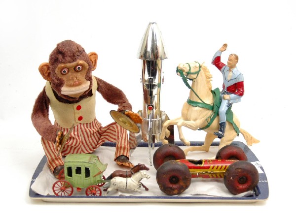 Battery operated plush monkey with cymbals (some w: Battery operated plush monkey with cymbals (some wear to his nose), metal stage coach (driver missing, white horse has broken legs), metal rocket ship bank by Astro Mfg., U.S.A., Marx Bouncing Benny, 