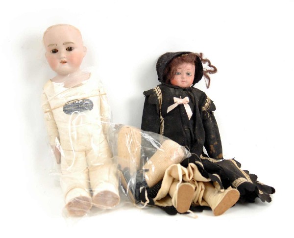 Two dolls including Armand Marseille Floradora, ha: Two dolls including Armand Marseille Floradora, hair eyebrows, approximately 19", kid body needs repair, and 14" papier mache doll with cloth body and blue glass eyes