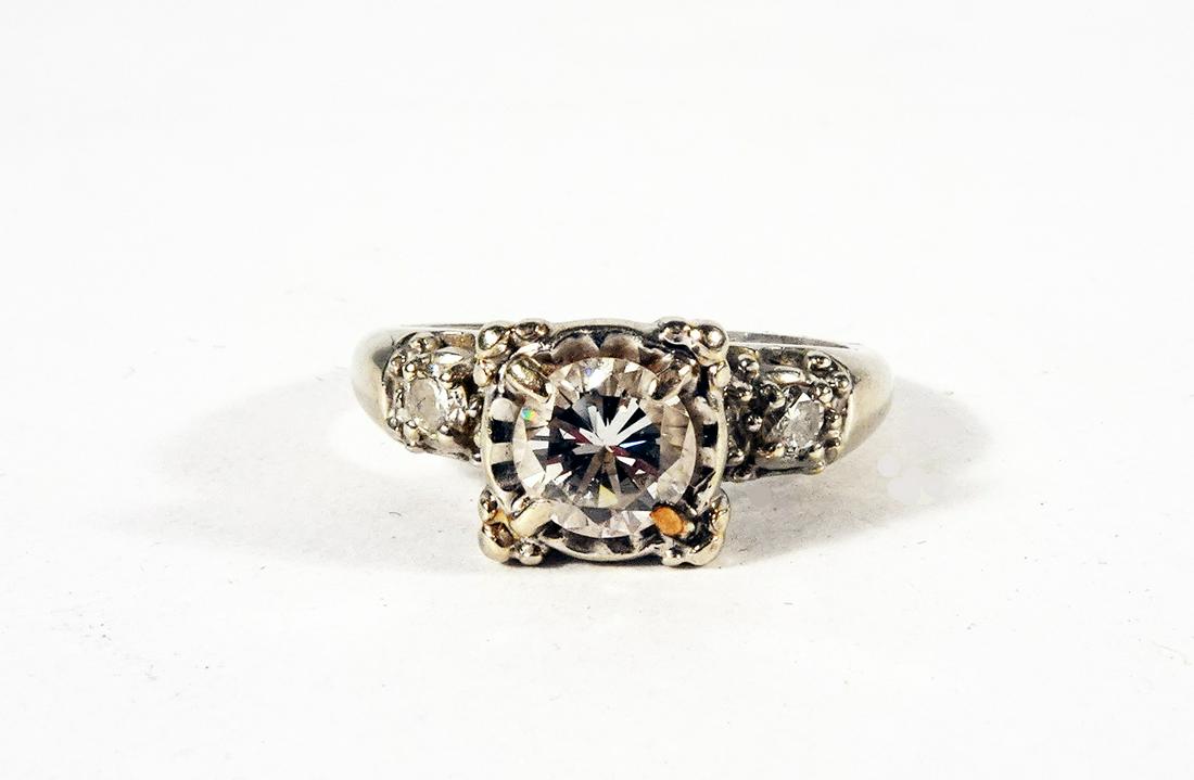 Diamond White Gold Vintage Engagement Ring: Diamond white gold vintage engagement ring; stamped: 14k TQW and prong set into illusion plates three round full cut diamonds. 1ea@ 5.6mm (.65ct)2ea@2.5mm (.06ct ea.) (VS/ft y) Weight: 4.4gr.