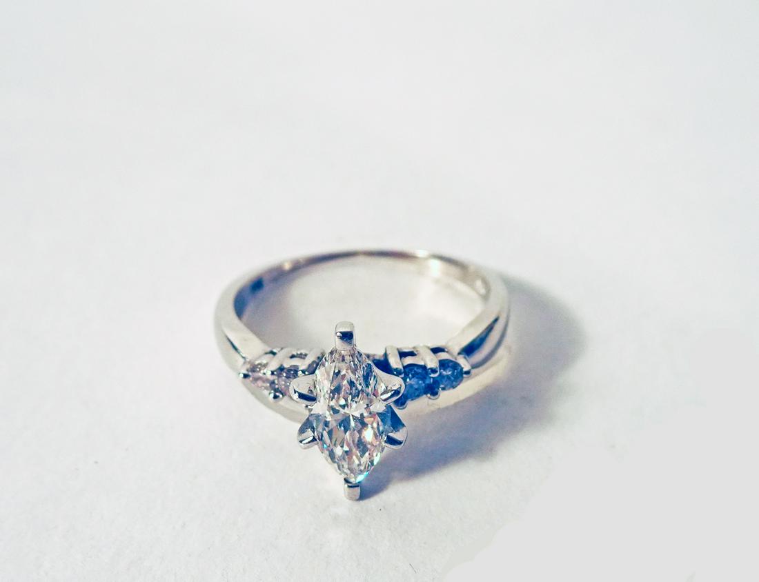 Diamond and White Gold Ring: Diamond and white gold ring, marquis shaped center diamond flanked by two small diamonds on each side, .73 ct. F SI 1, stamped:14K, 2.86 gr., finger size 7