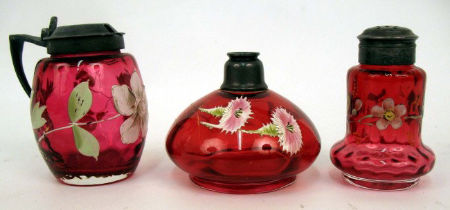 Three pieces of enameled cranberry glass including : Three pieces of enameled cranberry glass including miniature oil lamp 2 1/2" high, 3" condiment with Starburst & Fan pewter lid, and a 2 3/4" shaker