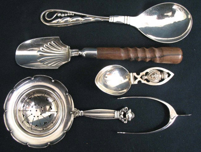 Grouping of sterling silver flatware including 6" : Grouping of sterling silver flatware including 6" Georg Jensen sugar scoop, 5" Georg Jensen tea strainer (both 1910-1925), a Gorham 6 1/2" marrow scoop with wooden handle, an 800 silver spoon with pie