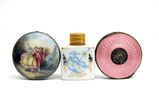 Two sterling silver enameled compacts and a porcel: Two sterling silver enameled compacts and a porcelain perfume bottle including compact with hand painted courting scene, white enamel sides, 2" diameter, marked Sterling Germany, one compact with pink