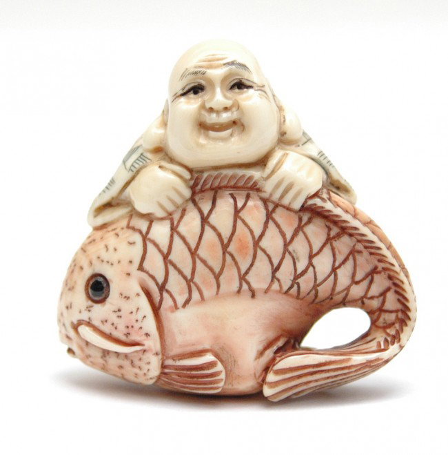 Hand carved ivory netsuke, smiling Buddha with lar: Hand carved ivory netsuke, smiling Buddha with large fish, hand colored, signed, 1 5/8" high, mid 20th C.