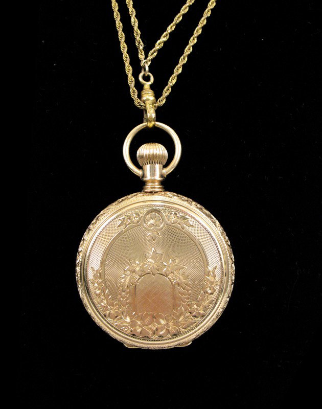 Elgin 14K gold cased pocket watch, hunting case wi: Elgin 14K gold cased pocket watch, hunting case with engraved design on both sides, movement marked 2173110, case marked M.F. & Co. 385198, 1 1/2" diameter, includes 50" long gold filled chain, early 
