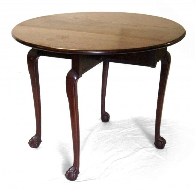 Kittinger Williamsburg Chippendale style cherry dr: Kittinger Williamsburg Chippendale style cherry drop leaf table, ball and claw feet, branded mark and paper label, 20th C., closed measures 27" high x 34" across x 12" deep, open measures 27" high x 3