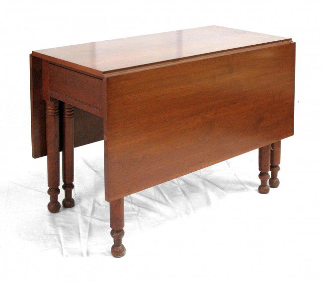 Cherry gate leg dining table, one drawer,: Cherry gate leg dining table, one drawer, round legs with turnings at knees and ankles, ball feet, six legs, mid 19th C., measures 29 1/4" high x 42 1/4" across x 56 3/4" deep open, measures 21 1/2" d