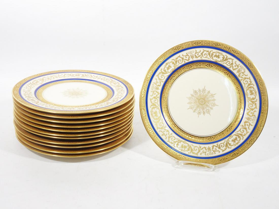 Twelve George Warrin Porcelain Dinner Plates: Set of twelve George Warrin porcelain dinner plates, decorated with hand painted gilt and scroll stylings, pattern was designed by George Warrin who died in 1914, all are marked on verso "U.S.A. with 