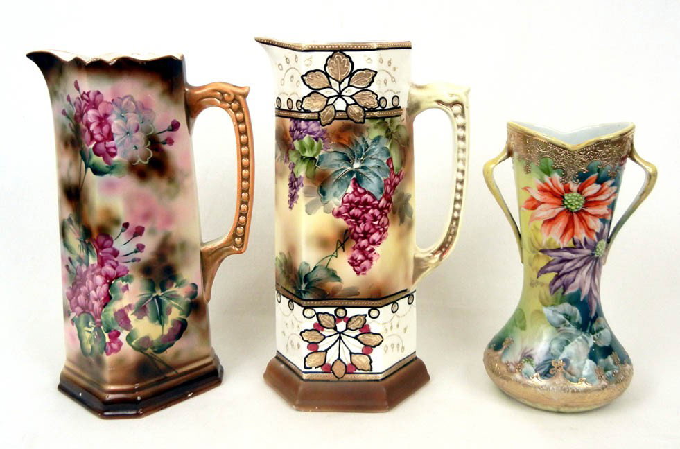 Three pieces of Nippon including two Royal Nippon N: Three pieces of Nippon including two Royal Nippon Nishiki tankards, both with floral designs, and a Nippon handled vase with gilt and floral decoration, blue maple leaf mark on bottom, 12 1/2" high, 1