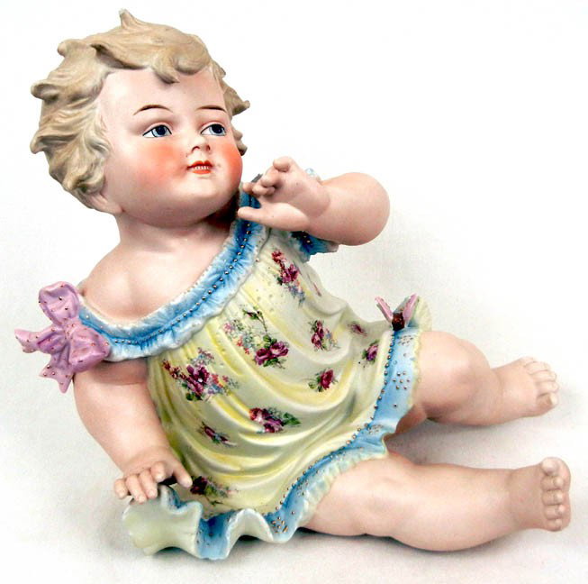 Heubach piano baby, seated, intaglio eyes, 11" hig: Heubach piano baby, seated, intaglio eyes, 11" high x 11" across x 10" deep, late 19th C.