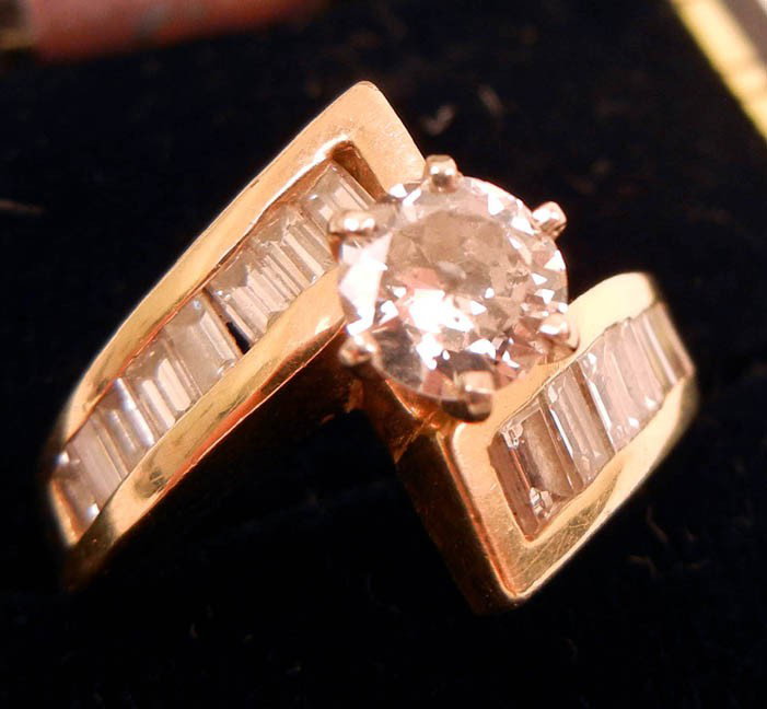 14k gold diamond solitaire engagement ring, round : 14k gold diamond solitaire engagement ring, round center stone measures approximately 65 points, nine baguettes on either side ranging in size from 6 to 8 points each, size 5, marked 14k S.K.H., weigh