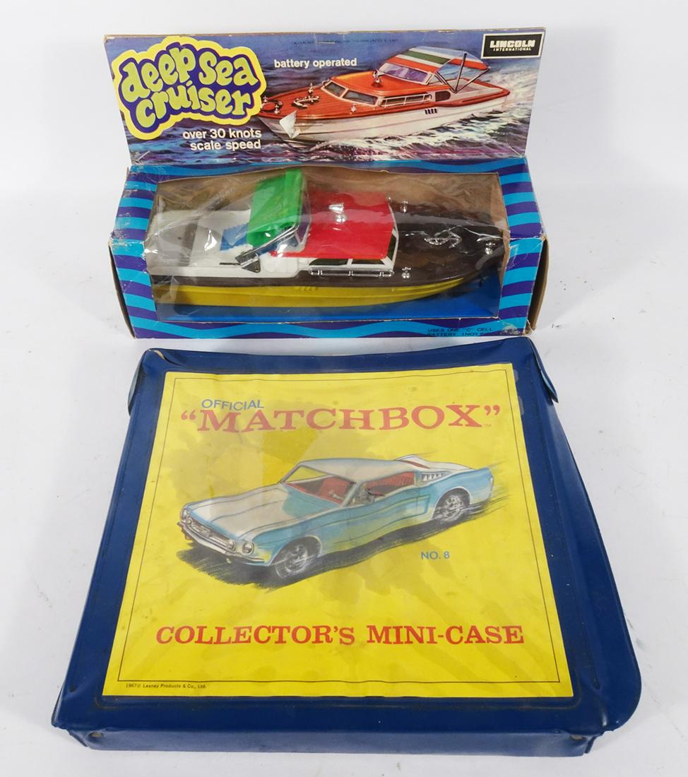 Die-cast vehicles in Matchbox case and a battery op. cabin cruiser in original box. (1 of 3)