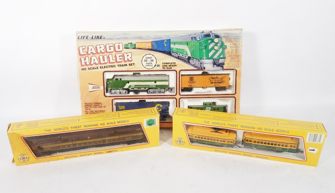 1980's HO gauge trains in original boxes.: 1980's HO gauge trains in original boxes. First is a Life Like 4 piece freight set with track and power pack. Engine is a dummy. Next is a Mehano PRR GG-1 in original box. Last is Mehano twin trolleys