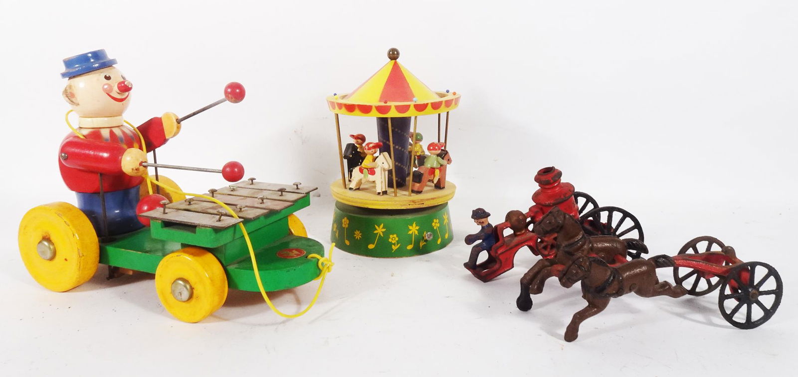 Two European wooden toys and a 9" cast iron fire engine. (1 of 4)