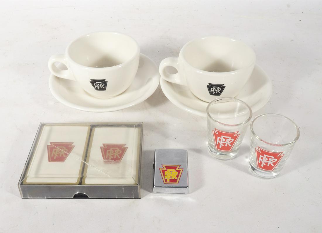 and Contemporary PRR Collectibles Lot: Pennsylvania Railroad collectibles lot, two circa 1940's-1950's Buffalo China Inc. pottery cups and saucers, circa 1950's United States Playing Card Co. playing cards with case, circa 1950's-1960's Zi