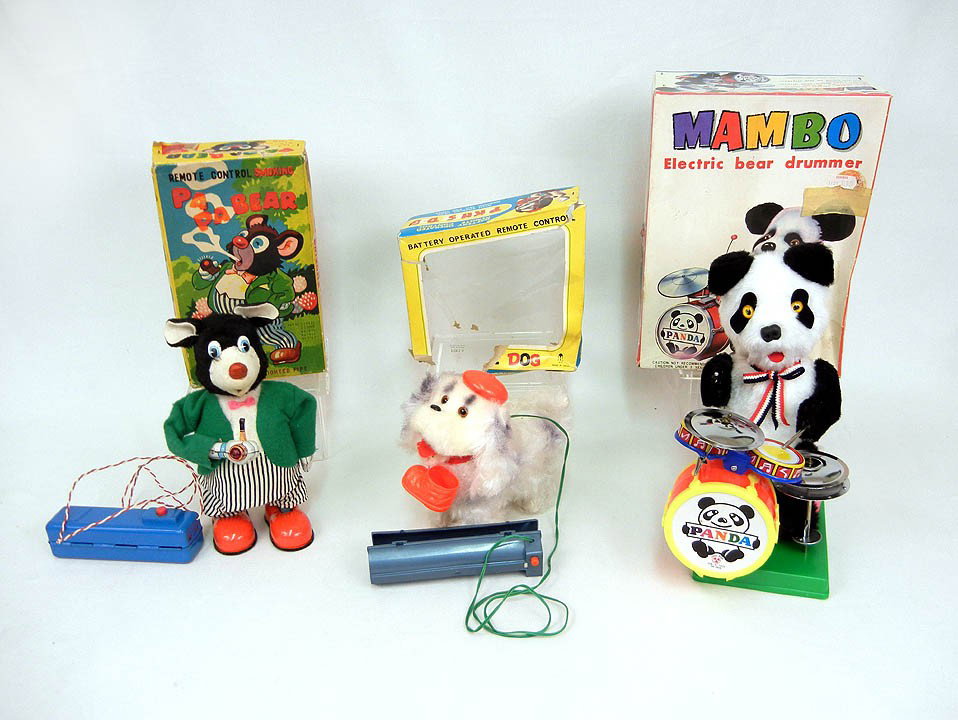Three battery operated toys including 1). Mambo Be: Three battery operated toys including 1). Mambo Bear Drummer with original box by Son A1 Toys Taiwan, 9 1/2" high, 2). Remote Control Smoking Papa Bear in original box by Marusan Toys Japan, 8 1/4" hi