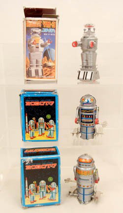 Three wind-up robot toys in original boxes: includes two Robot-7 mechanical walking wind-ups, made in Taiwan, each 4" high, both in working order, and a Robot YM-3, 4 1/2" made in Japan, working, all with original boxes